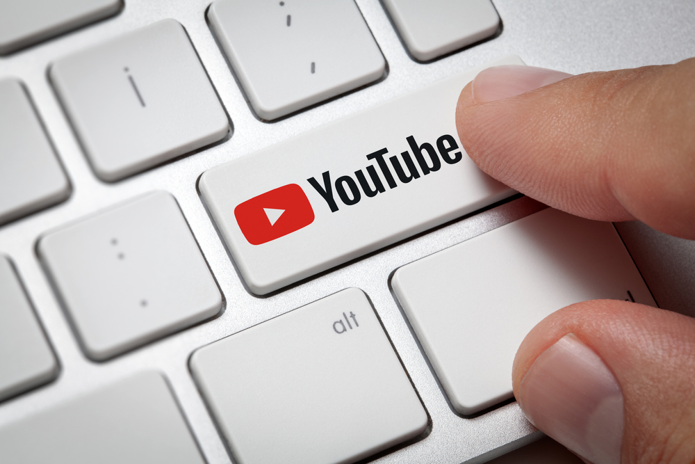 A man pressing on an YouTube button